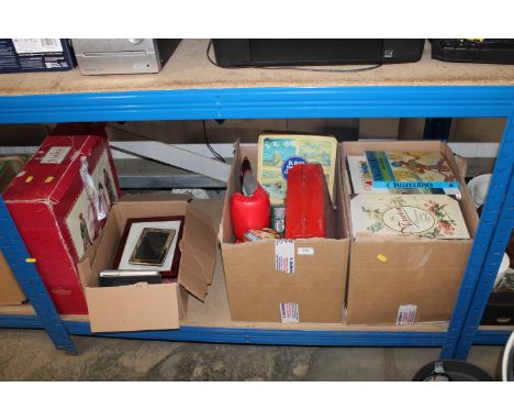 Four boxes containing various books, picture frames, a Nativity set, boxing gloves etc.