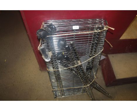 A metal three tier shelf on wheels