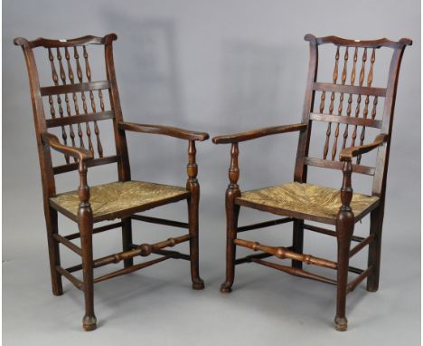 Two 19th century Lancashire-type spindle-back elbow chairs with woven rush seats, &amp; on turned &amp; tapered legs with tur