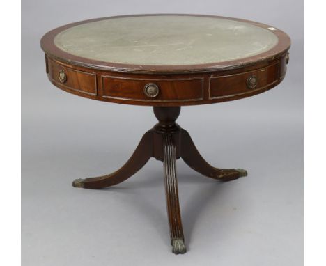 A regency-style mahogany drum-top centre table inset gilt-tooled green leather, fitted four frieze drawers, &amp; on a vase-t