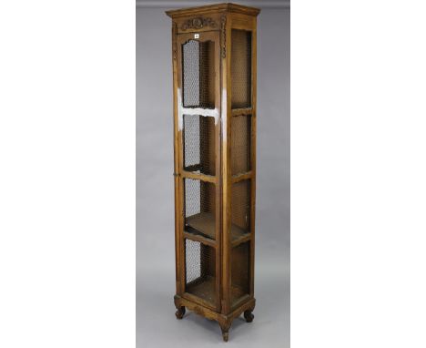 A continental-style tall oak-finish cabinet fitted three shelves enclosed by a mesh-fronted door, with mesh-fronted sides, &a