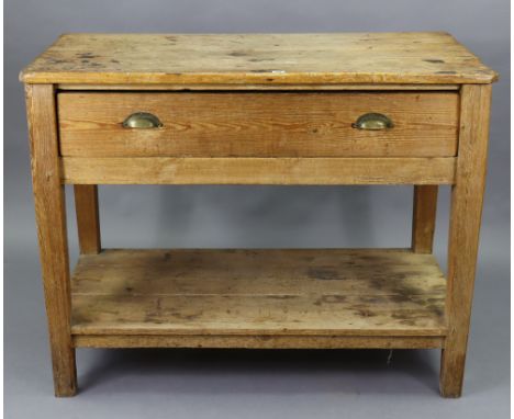 A 19th century pine kitchen table fitted with a frieze drawer, &amp; on square tapered legs with an open undertier, 46¾” wide