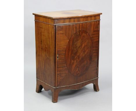 An inlaid-mahogany dwarf upright cabinet fitted with a centre shelf enclosed by a panel door, &amp; on o-gee bracket feet, 25