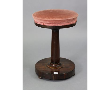 A William IV rosewood stool with a padded circular revolving seat, &amp; on a round tapered centre column &amp; circular plat