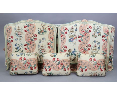 A Treca of Paris carved &amp; painted wooden single bedstead upholstered in multi-coloured floral material, 35½” wide; with b