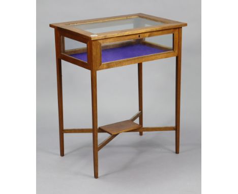 An Edwardian inlaid-mahogany bijouterie table, enclosed by glazed hinged lift-lid &amp; glazed sides, &amp; on square tapered