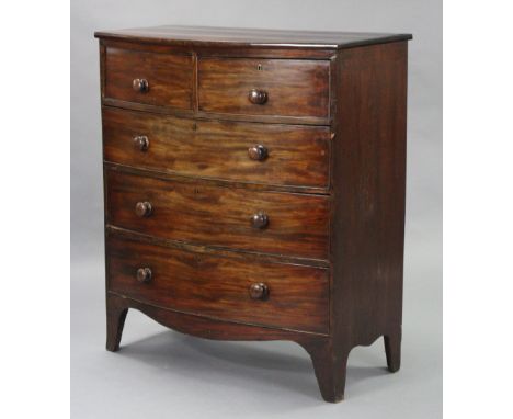 An early 19th century figured mahogany bow-front chest, fitted two short &amp; three long drawers with turned knob handles, o