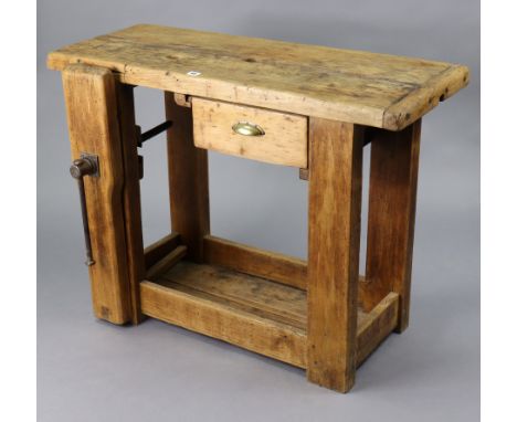 A small pine work-bench with a rectangular top, fitted with a frieze drawer, &amp; on square supports, &amp; fitted with a cl