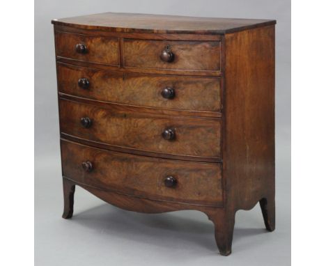 An early 19th century figured mahogany bow-front chest, fitted two short &amp; three long graduated drawers with turned knob 