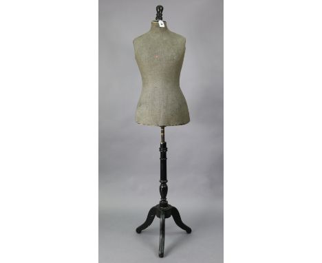 A vintage dressmaker’s dummy on an ebonised wooden tripod base, 60” high. 