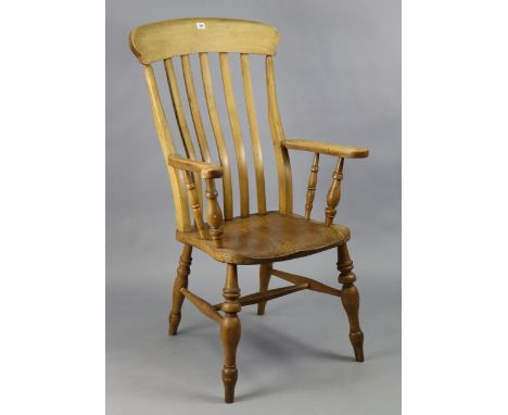 A similar Victorian beech lath-back elbow chair with a hard seat, &amp; on turned legs with spindle stretchers.