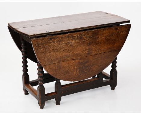 LATE 17TH CENTURY OAK GATELEG DROP LEAF TABLE
circa 1680, with single end drawer on six bobbin turned supports united by stre