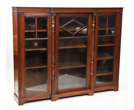EARLY 20TH CENTURY OAK BREAKFRONT BOOKCASE
with two carved columns between three astragal glazed doors, on bracket feet, 177c