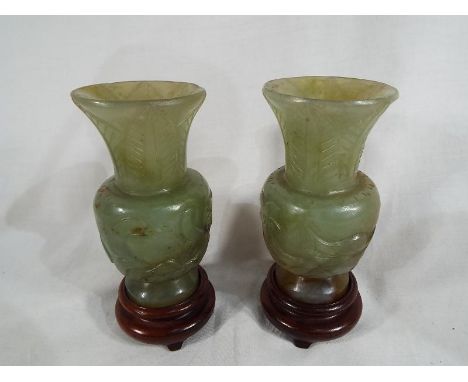 A pair of 19th century Chinese jade vases with carved decoration on wooden stands, 12cm Est £200 - £300