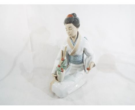 A large Nao by Lladro figure depicting an Asian girl 34 cm (h)