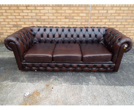 A Chesterfield Sofa, brown upholstered with button back arms and seat, 67 cm x 200 cm x 83 cm