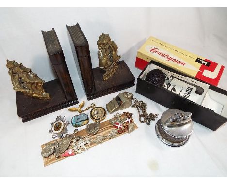 A good mixed lot to include a small collection of vintage lapel badges, a Thunderer whistle, a smoker's pipe, a cigarette lig
