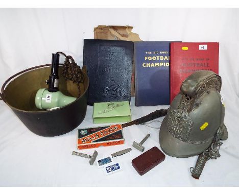 A British standard Merryweather Pattern Fire Helmet # 2 with embossed decoration, dragon to each side, crossed axe decoration