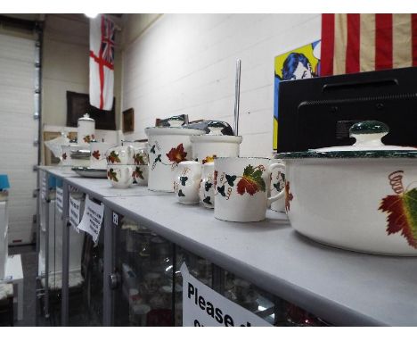 Poole Pottery - a collection of tableware decorated in The Autumn Leaves pattern comprising approx 40 pieces to include cups,