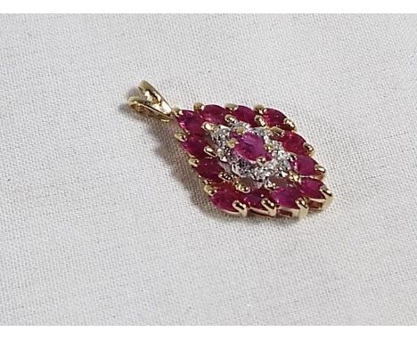 A lady's 9 carat gold ruby and diamond pendant. Estimate £20 - £40