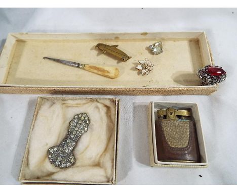 A collection of costume jewellery to include a graduated pearl necklace, a collection of pearls, a collection of brooches, in