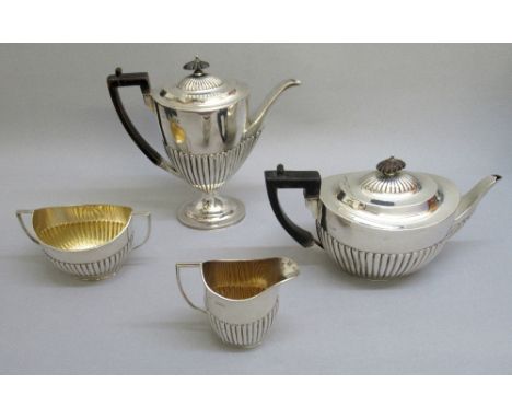 VICTORIAN MATCHED SILVER TEA AND COFFEE SET OF SEMI-FLUTED OVAL FORM COMPRISING A TEAPOT, COFFEE POT, SUGAR BASIN AND CREAM J