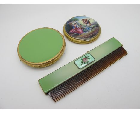 A Vintage German Enamel Ladies Compact, hand painted to the front with figures within a rural setting (scratches); together w