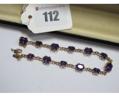 A 9ct Gold Amethyst Set Bracelet, graduated oval claw set throughout, to snap clasp, overall length 19cm.