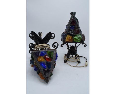 A 1960s wrought iron and coloured glass table lamp together with a hanging lantern, believed to be made by Peter Marsh (unmar