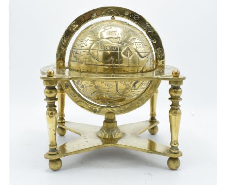 A 20th century cast brass spinning globe with star signs and dates of the month on the support frame. In good functional cond