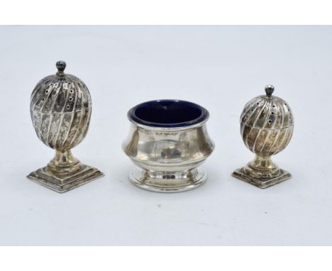 A collection of hallmarked silver items to include acorn shaped cruet shakers (42.3 grams of silver) and a silver inkwell/pot