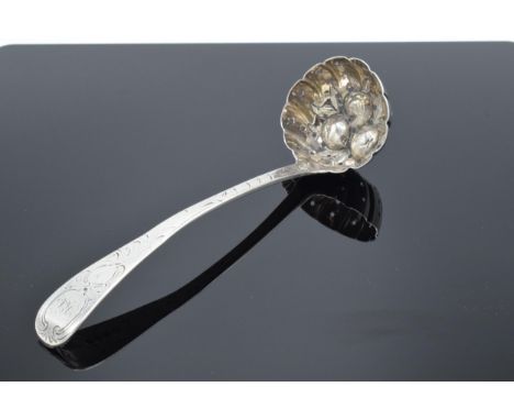 A George III silver sifter ladle embossed with fruit decoration 54.8 grams. Monogram to the top of the handle. Hallmarked Lon