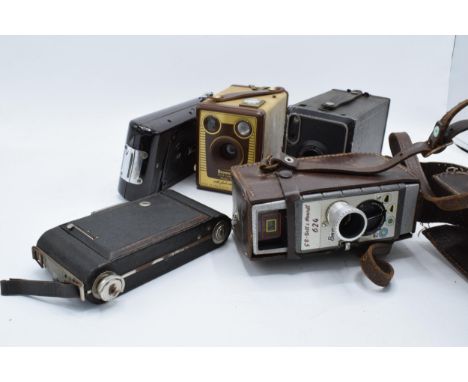 A collection of vintage cameras in carry cases to include a Brownie Six-20 Model F, Kodak Brownie No. 2, Bell and Howell 624,