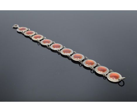 A 20th century sterling silver and red enamel bracelet. 14.5 grams. 19cm long. In good condition generally with some minor da
