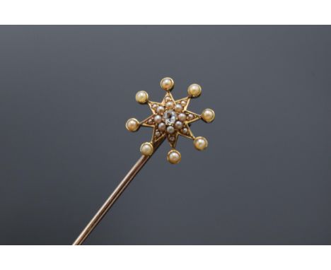 Tested as 15 carat gold pearl and diamond star hat pin on a base metal pin. 13.5 cm tall. 