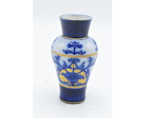 A Macintyre / Moorcroft small baluster vase with stylised decoration. 11cm tall. In good condition with no obvious damage or 