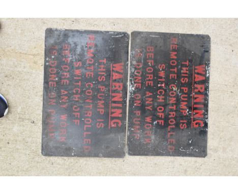A pair of vintage 20th century enamel signs 'Warning this pump is remote controlled switch off before any work is done on pum