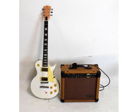 White six-string electric guitar, having mother-of-pearl inlaid decoration to neck, together with Stagg 20 AAK amplifier  