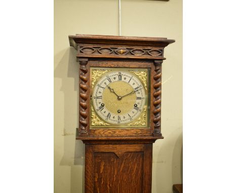 Early 20th Century oak grandmother clock having striking and chiming movement, the square brass dial with strike silent featu