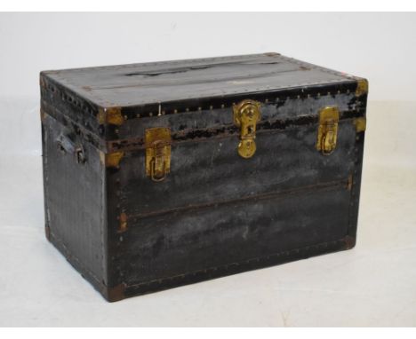 Vintage black travel trunk having hinged cover and leather carry handles, 84cm wide  
