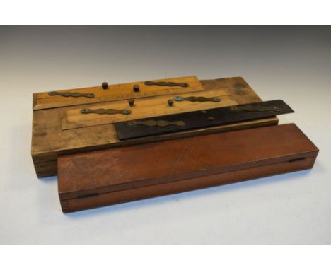 Group of scientific instruments to include cased brass slide rule, three parallel rules, protractor or station pointer (5)  