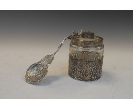 Continental white metal straining ladle, together with a cylindrical glass jar having repousse mounts, 11.5cm high (2)  