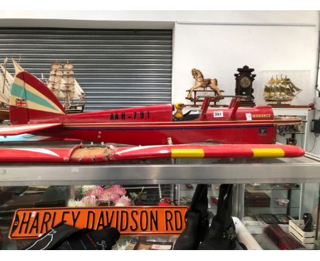 A RED PAINTED MODEL BIPLANE, THE NOSE TO TAKE A LIVE FUEL ENGINE