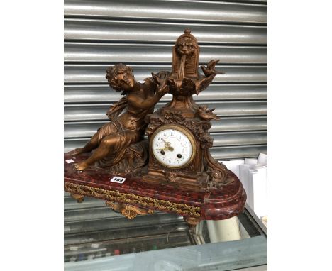 A LATE 19th C. FRENCH SPELTER AND MOTTLED RED MARBLE CLOCK WITH A LADY REACHING UP TO THE FOUNTAIN SURMOUNT