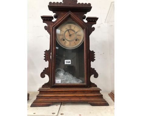 AN ANSONIA CLOCK STRIKING ON A COILED ROD AND IN A GLAZED WOODEN CASE