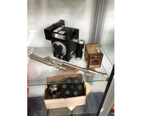 A POLAROID M403R CAMERA WITH A TRIPOD TOGETHER WITH A KODAK BROWNIE FLASH IV BOX CAMERA