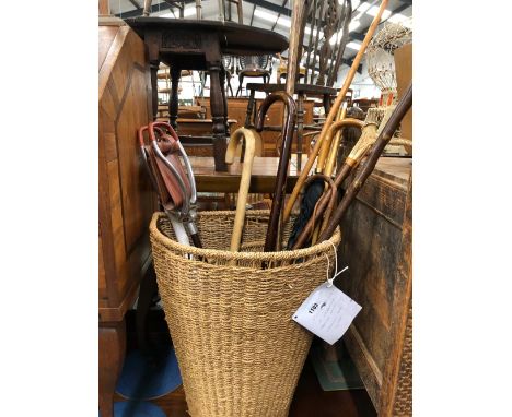 A WICKER HAMPER AND QUANTITY OF WALKING STICKS 