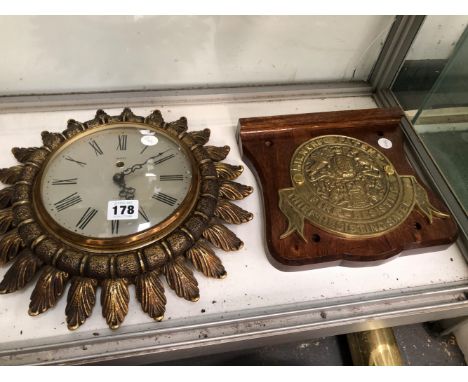 A SMITHS CLOCK IN A SUNBURST CASE TOGETHER WITH A MILNERS FIRE RESISTANT SAFE BADGE