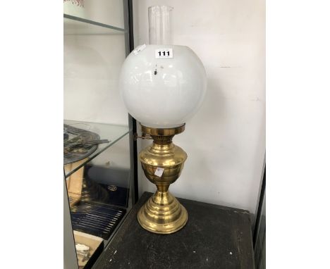 AN OIL LAMP WITH A BRASS RECEIVER