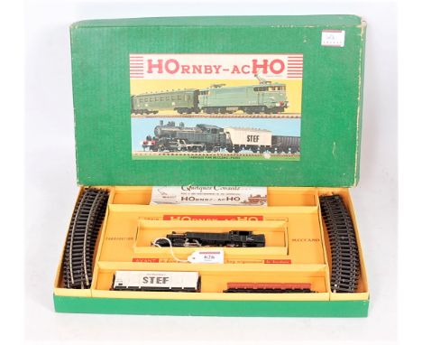 A Hornby AcH0 goods train set comprising 2-6-2 prairie tank engine SNCF black and 3 goods wagons, instructions and track, box
